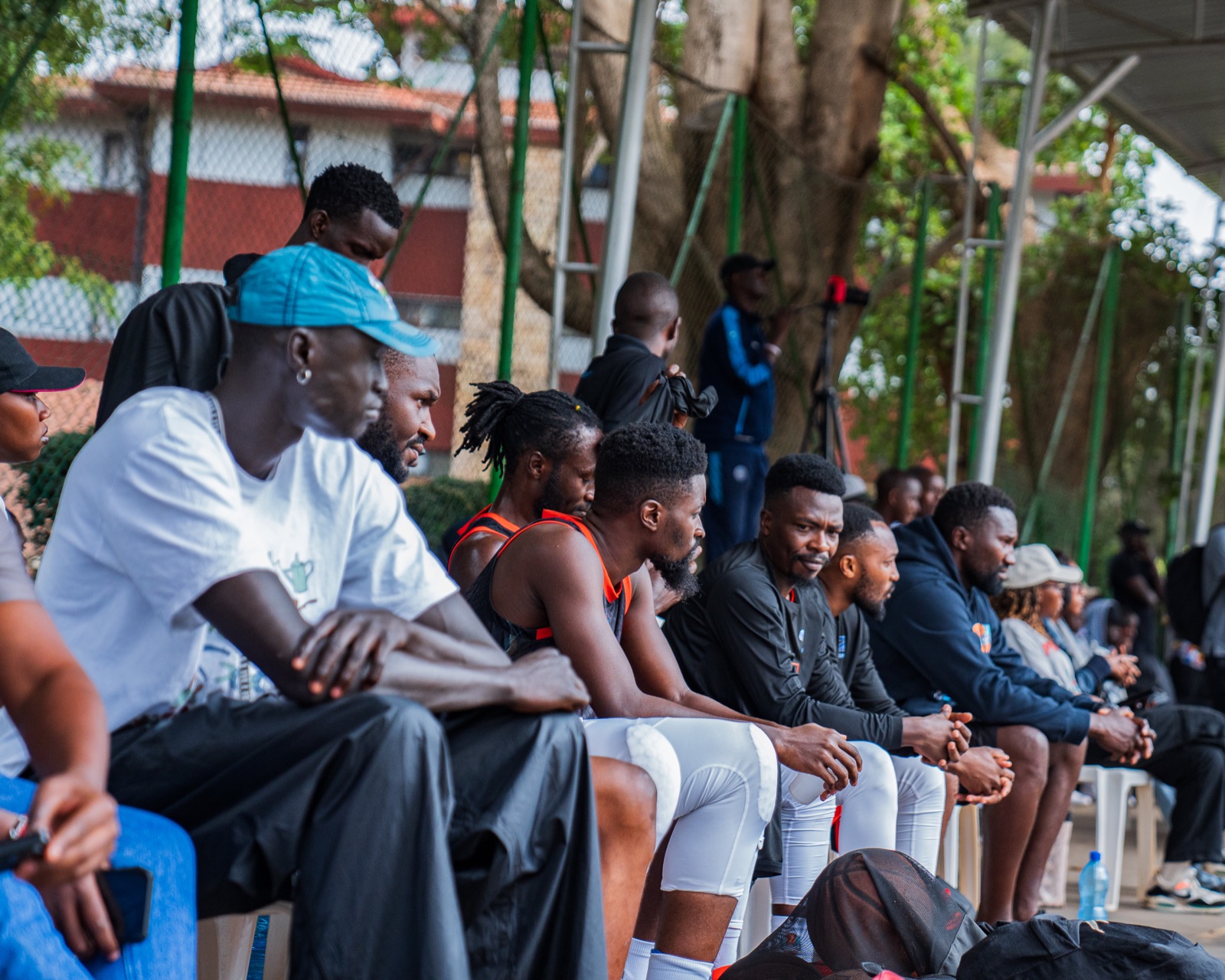 Umoja Basketball players watching from the bench