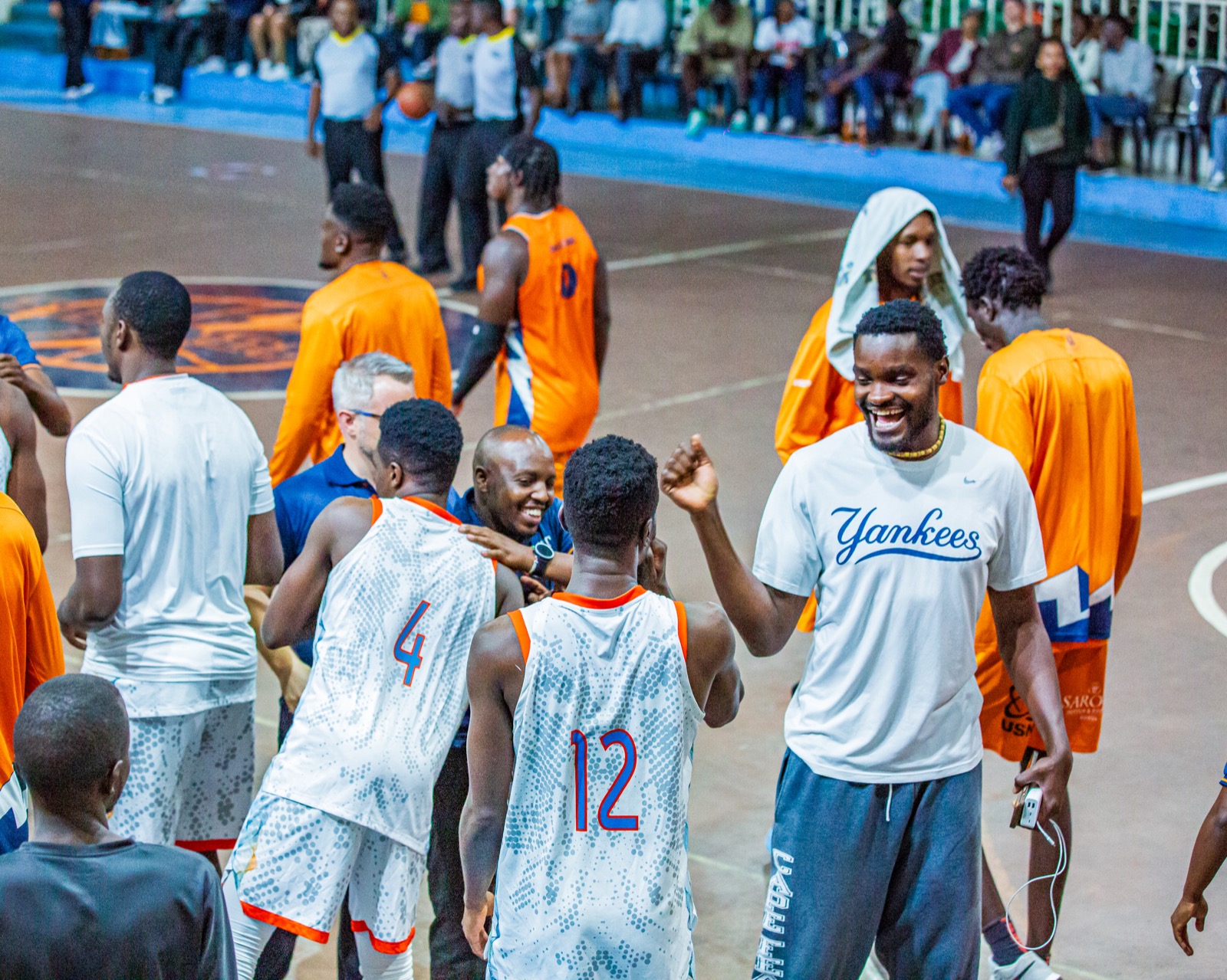 Umoja players and supporters smiling together after the game