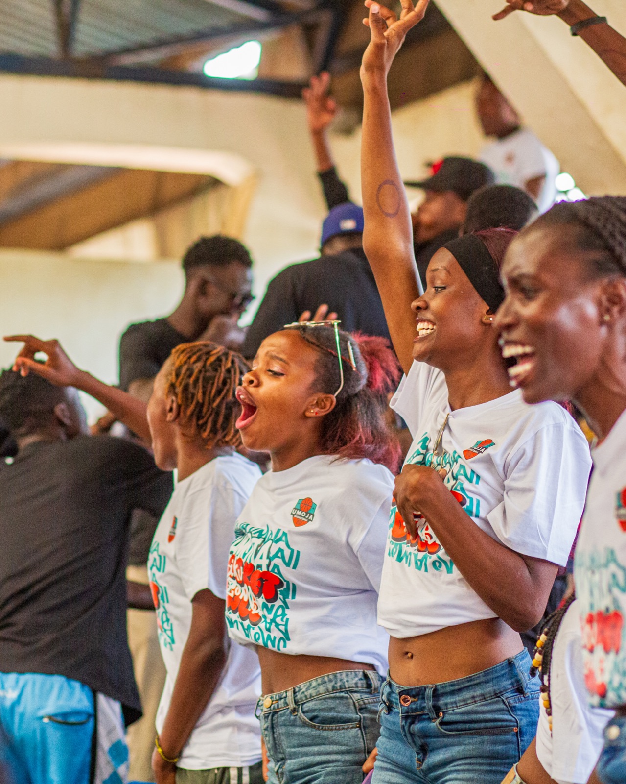 Umoja supporters reacting with raised arms in the stands